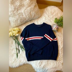 Blue knit sweater with red and white stripes in size small.